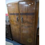 An early twentieth century walnut wardrobe and matching dressing table