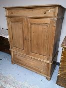 A rustic pine double door cabinet fitted with two drawers