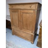 A rustic pine double door cabinet fitted with two drawers