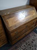 A nineteenth century oak bureau fitted with three drawers