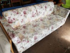 An early 20th century three seater settee in floral cover.