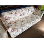 An early 20th century three seater settee in floral cover.