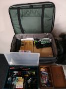 A suitcase containing boxes of tackle and fishing items