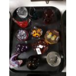 A tray of glass paperweights,