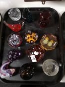 A tray of glass paperweights,