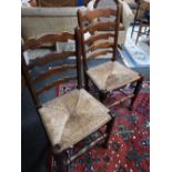 A pair of nineteenth century oak ladder backed country chairs