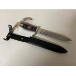 A reproduction German Hitler Youth dagger in sheath