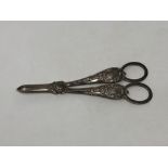 An ornate pair of Victorian silver candle snuffers,