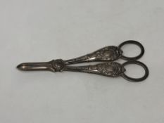 An ornate pair of Victorian silver candle snuffers,