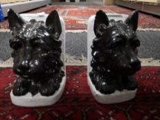 A pair of pottery book ends modelled as dogs