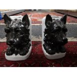 A pair of pottery book ends modelled as dogs