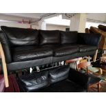 A Scandinavian black leather two seater and three seater settees.