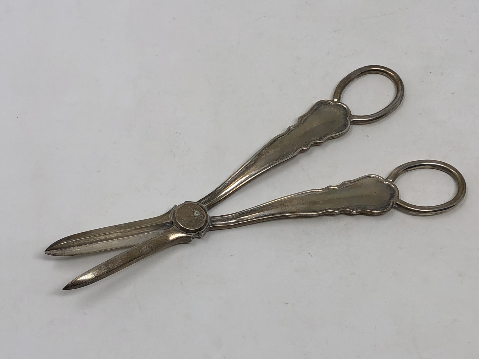 A pair of George V silver candle snuffers,