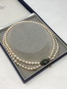 A good quality double strand of pearls with gold,