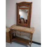 A wicker console table with matching mirror
