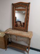 A wicker console table with matching mirror