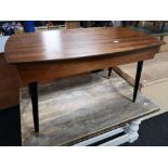 A teak storage table