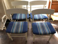 Four mid century white dining room chairs.
