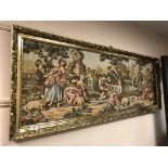 A gilt framed tapestry - lovers in a landscape