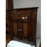 A reproduction oak corner cabinet