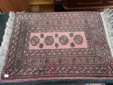 An Afghan fringed rug.