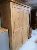 A traditional style pine double door wardrobe with interior shelf