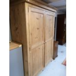 A traditional style pine double door wardrobe with interior shelf