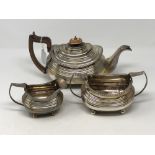 A Georgian silver three piece tea set comprising teapot, milk jug and sugar bowl, maker WB,