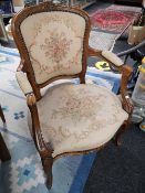 A carved walnut tapestry armchair