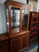 A reproduction yewwood glazed bookcase