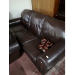 A brown leather three seater settee and matching two seater settee.