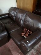 A brown leather three seater settee and matching two seater settee.