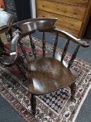 An antique elm half smoker chair