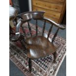 An antique elm half smoker chair