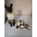 A Beswick Siamese cat together with other cat ornaments