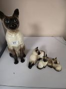 A Beswick Siamese cat together with other cat ornaments