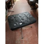 A mid century black studded leather swivel footstool.