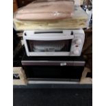 A microwave oven and cookworks table oven