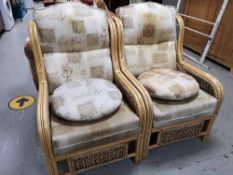 A pair of wicker conservatory armchairs and a cafe table