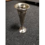 A slender silver spill vase