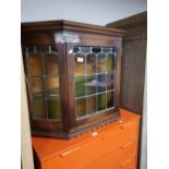 A leaded glazed oak wall cabinet