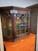 A leaded glazed oak wall cabinet