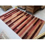 A contemporary striped rug, 243cm by 152cm CONDITION REPORT: In good condition.