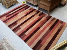 A contemporary striped rug, 243cm by 152cm CONDITION REPORT: In good condition.