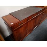 A reproduction yewwood sideboard