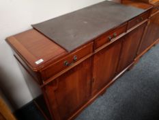 A reproduction yewwood sideboard