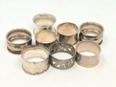 Eight silver serviette rings.