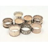 Eight silver serviette rings.