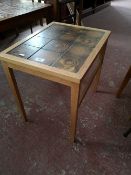 A light oak Scandinavian lamp table with tiled top.