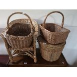 A collection of wicker ware - three baskets and a small chair.